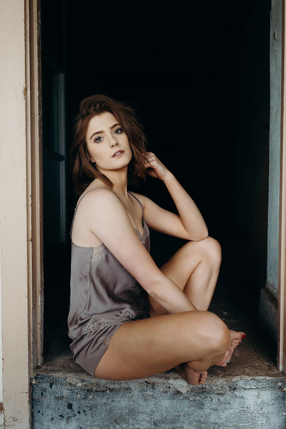 Young woman sits in doorway