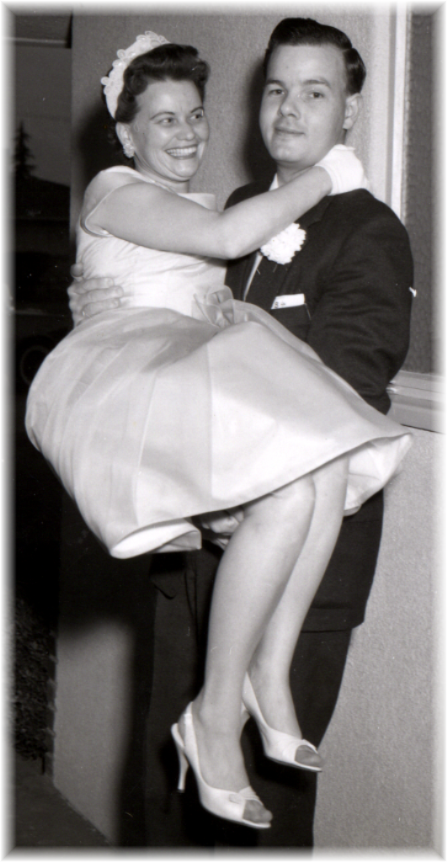 black and white photo of a happy bride and groom on their wedding day from the 1950's