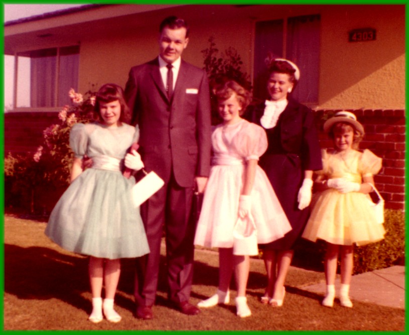 family of five: dad, mom, and three daughters pose outside their home in the 1960's