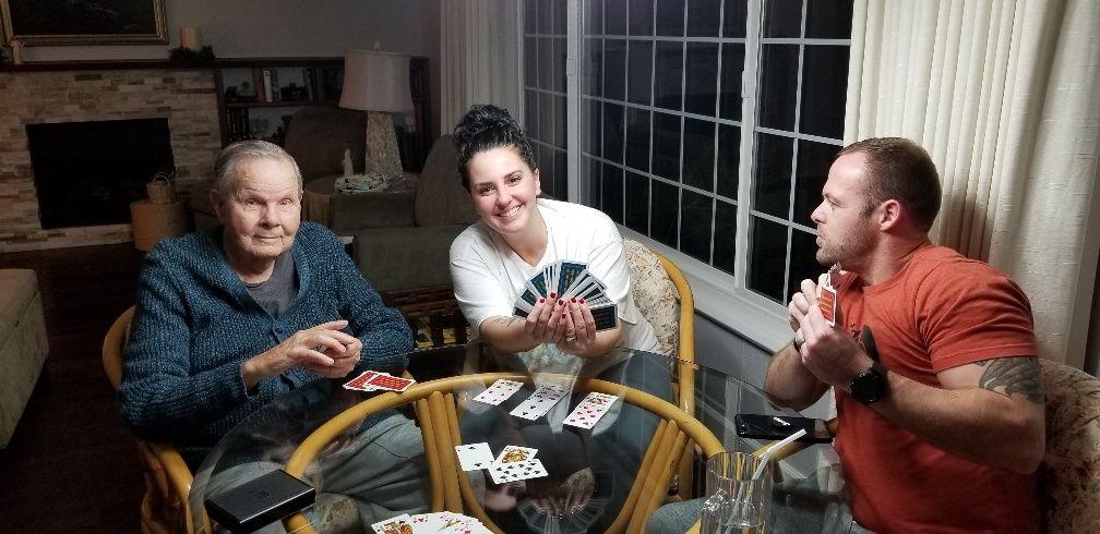 grandkids playing cards with grandpa