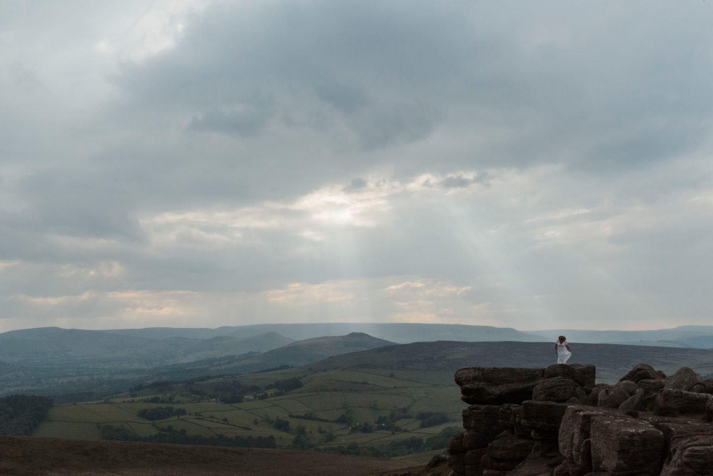 Woman standing on Stanage Edge, a Pride and Prejudice Filming location