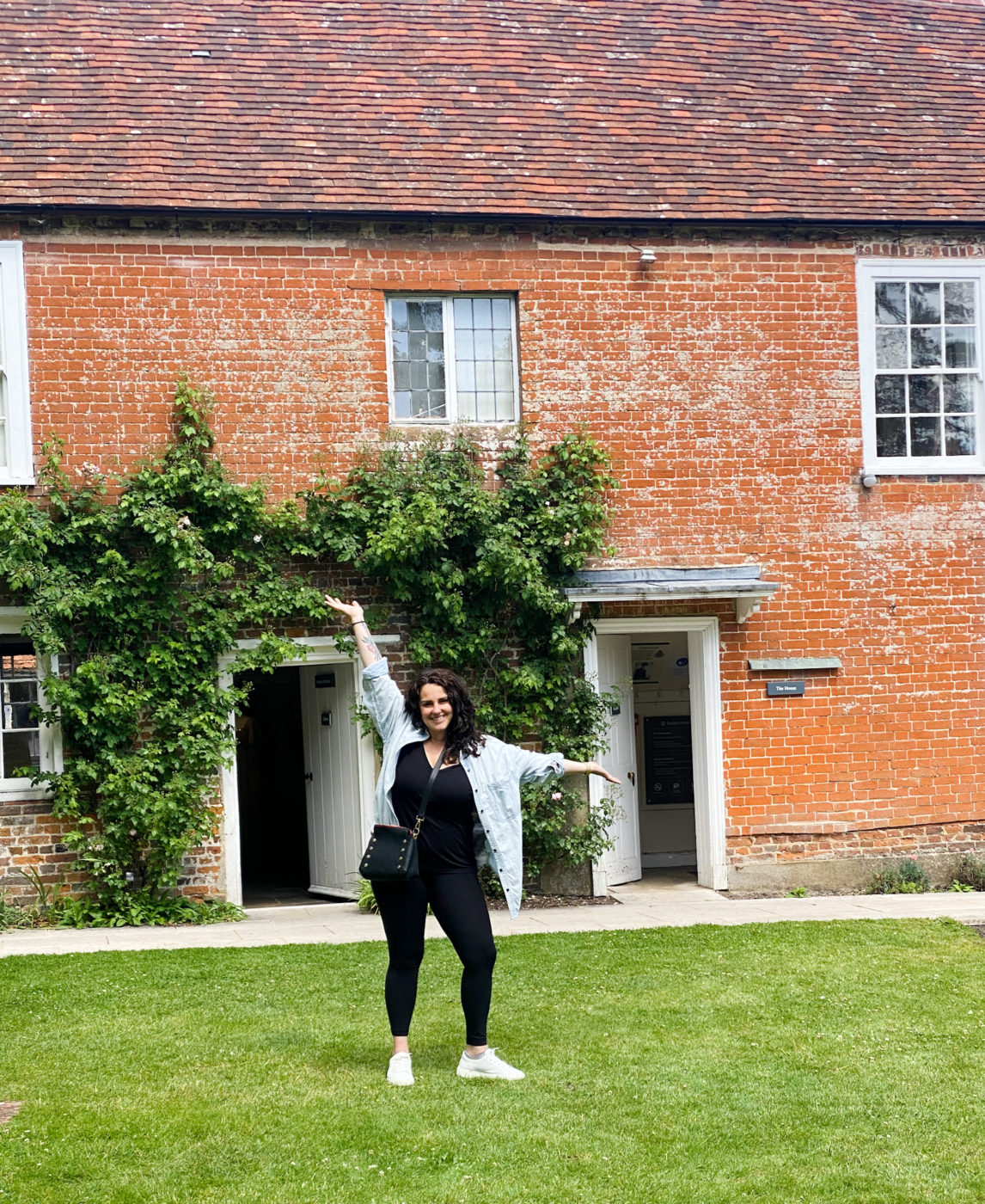 woman out front of Jane Austen's home in Chawton, Hampshire