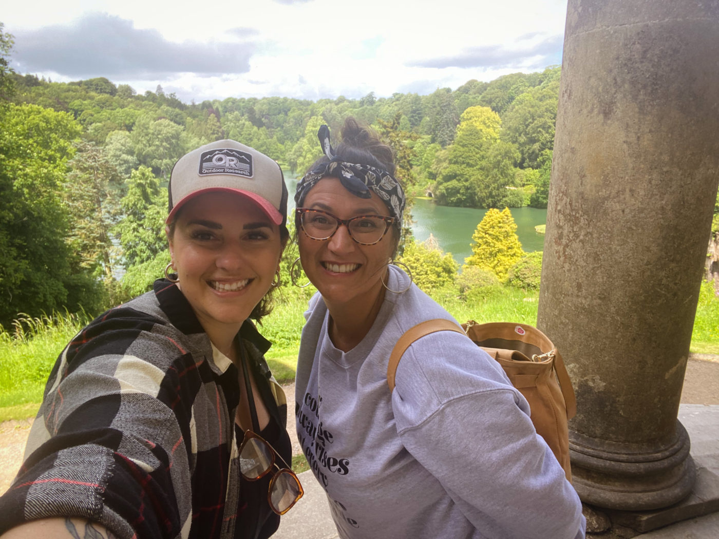 two friends stand on steps of Pantheon in Stourhead