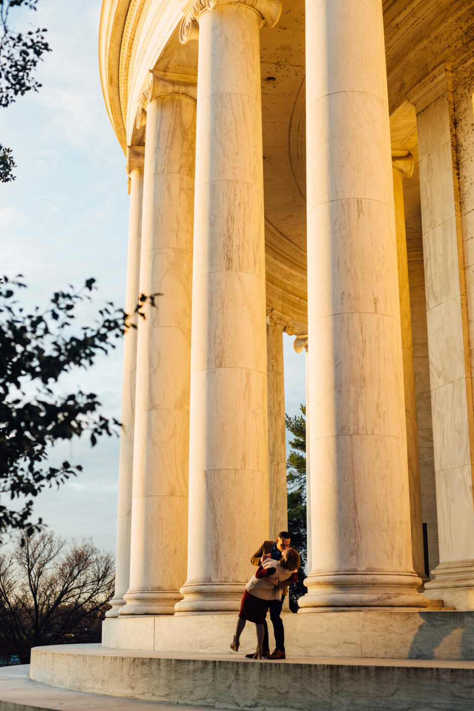 A husband dips his wife as they dance on the steps of the Jefferson Memorial in Washington D.C.