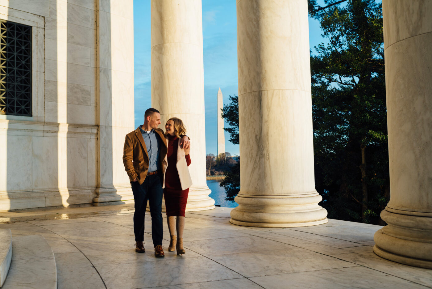 A young couple walks on the Thomas Jefferson Memorial